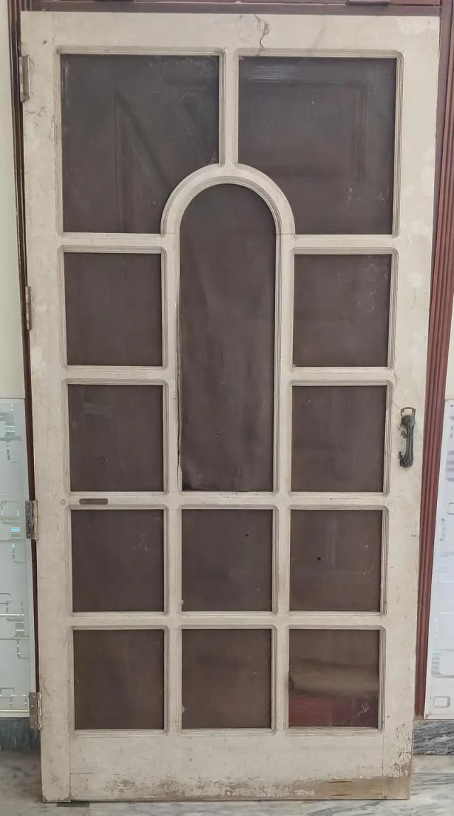 wodden door with metal handle and bolt