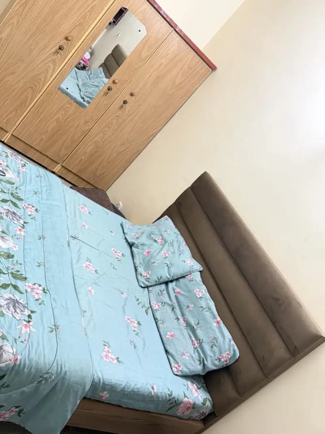 Queen-size bed with mattress and wardrobe.